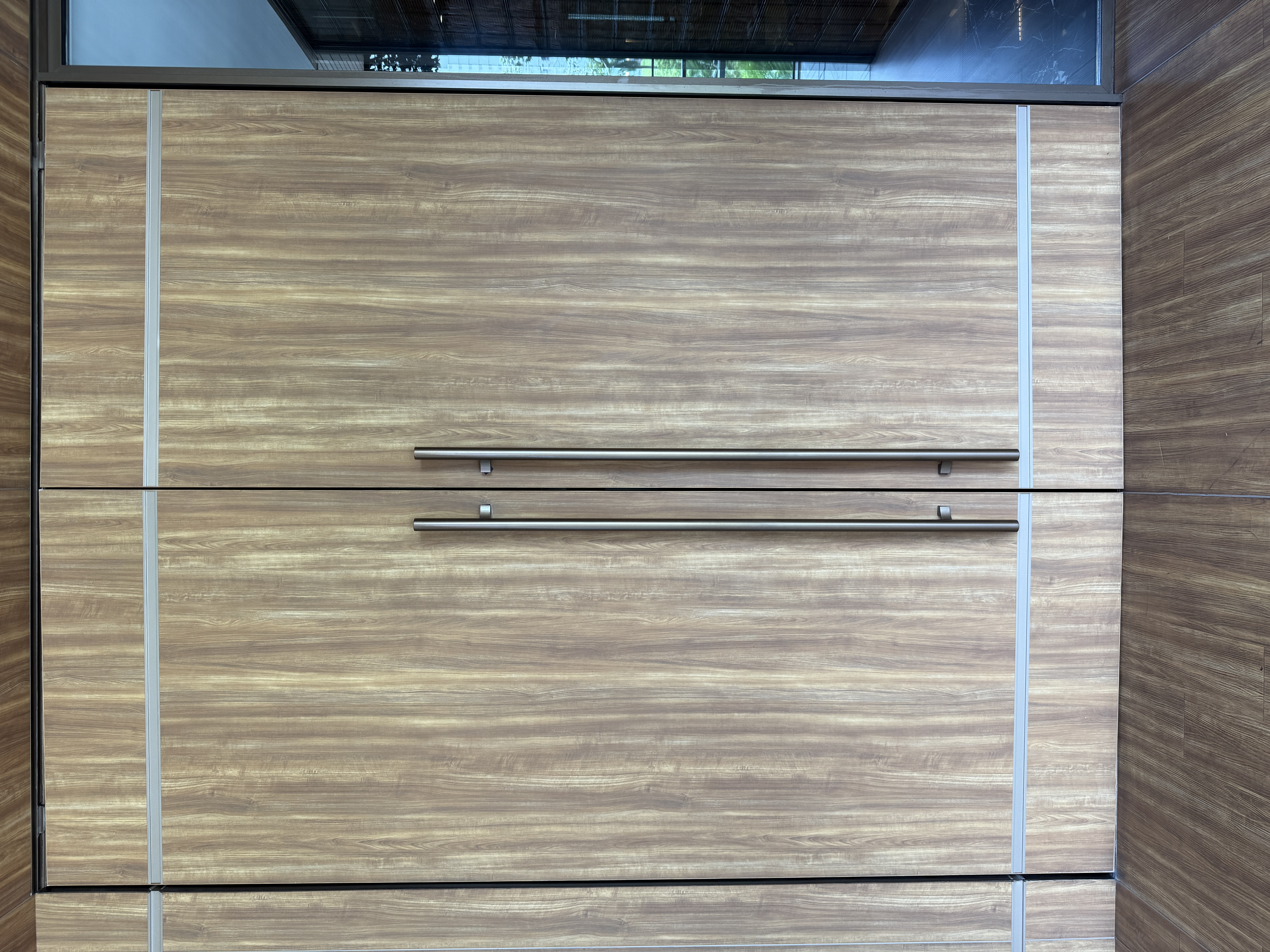 Detalle de puerta integrada con acabado tipo madera en RAZA